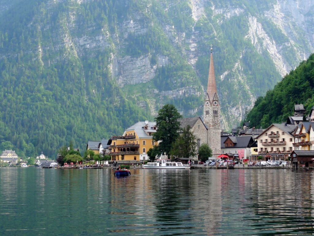 Hallstatt church tower with alpine mountains and lake in Austria