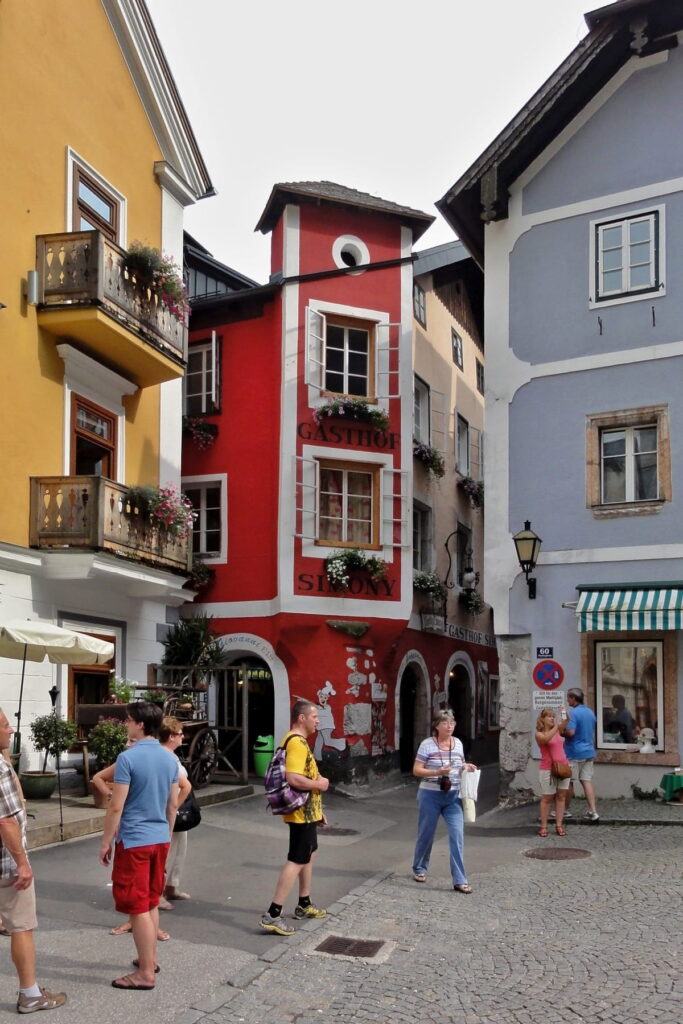 Narrow street with colorful buildings in Hallstatt old town, Austria
