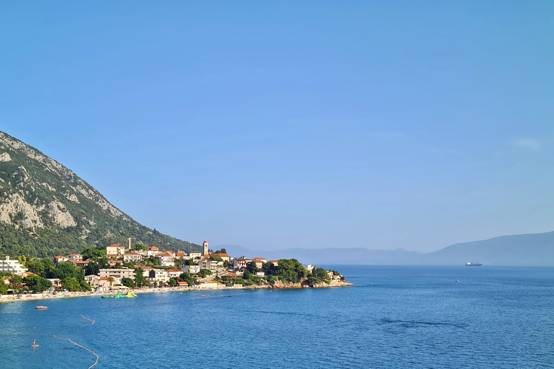 Coastal village with sandy beach and hills overlooking the Adriatic Sea in Croatia