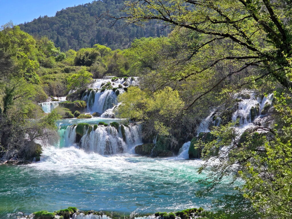 Multi-level waterfalls framed by trees in Krka National Park, Croatia