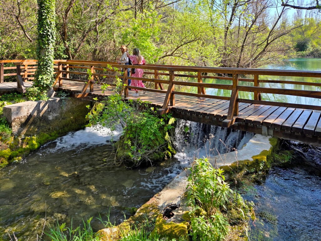Visitors crossing a wooden bridge in Krka National Park, Croatia