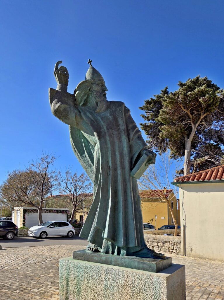 Bronze statue of Bishop Grgur holding a book in Nin, Zadar County, Croatia