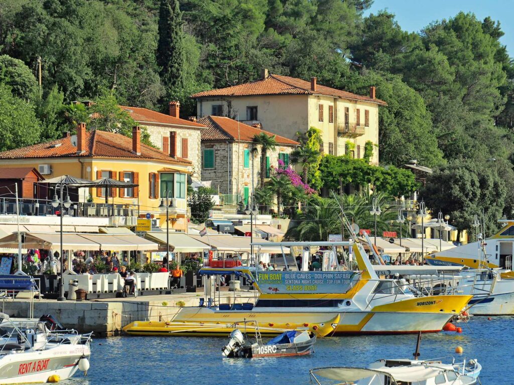 Boats and waterfront cafés in Rabac harbor on the Croatian coast