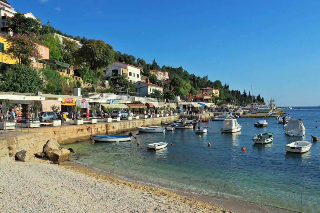 Seafront promenade with boats and cafés in Rabac, Croatia