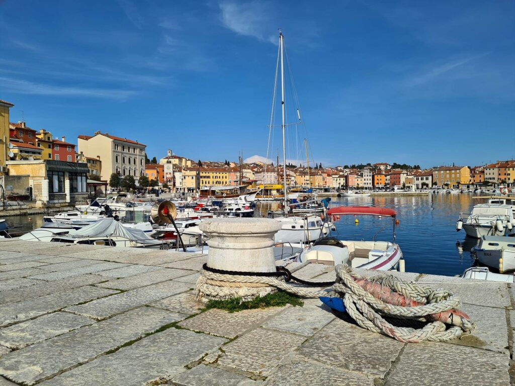 Boats moored in Rovinj marina along the waterfront promenade in Croatia