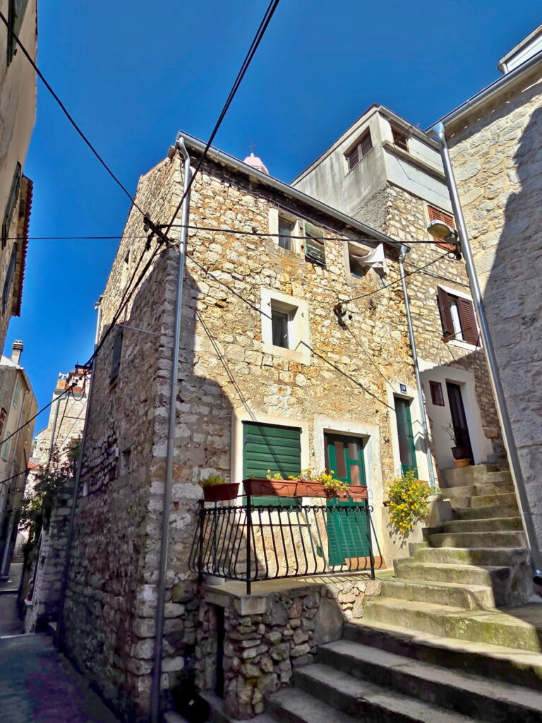 Narrow stone alley with old houses in Šibenik, Croatia
