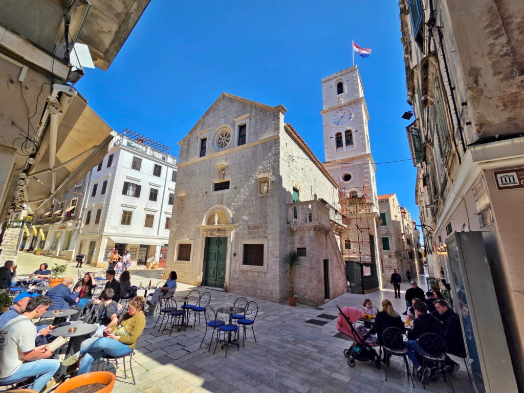 Historic church square with clock tower in Šibenik, Croatia