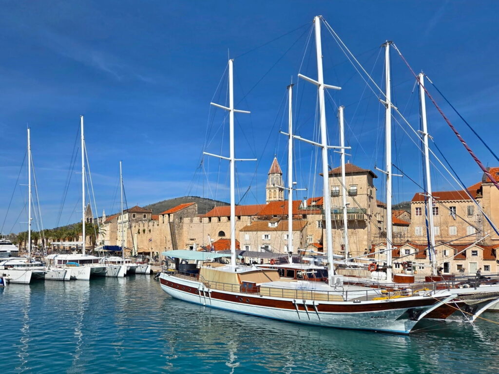 Sailboats and historic waterfront in Trogir, Croatia