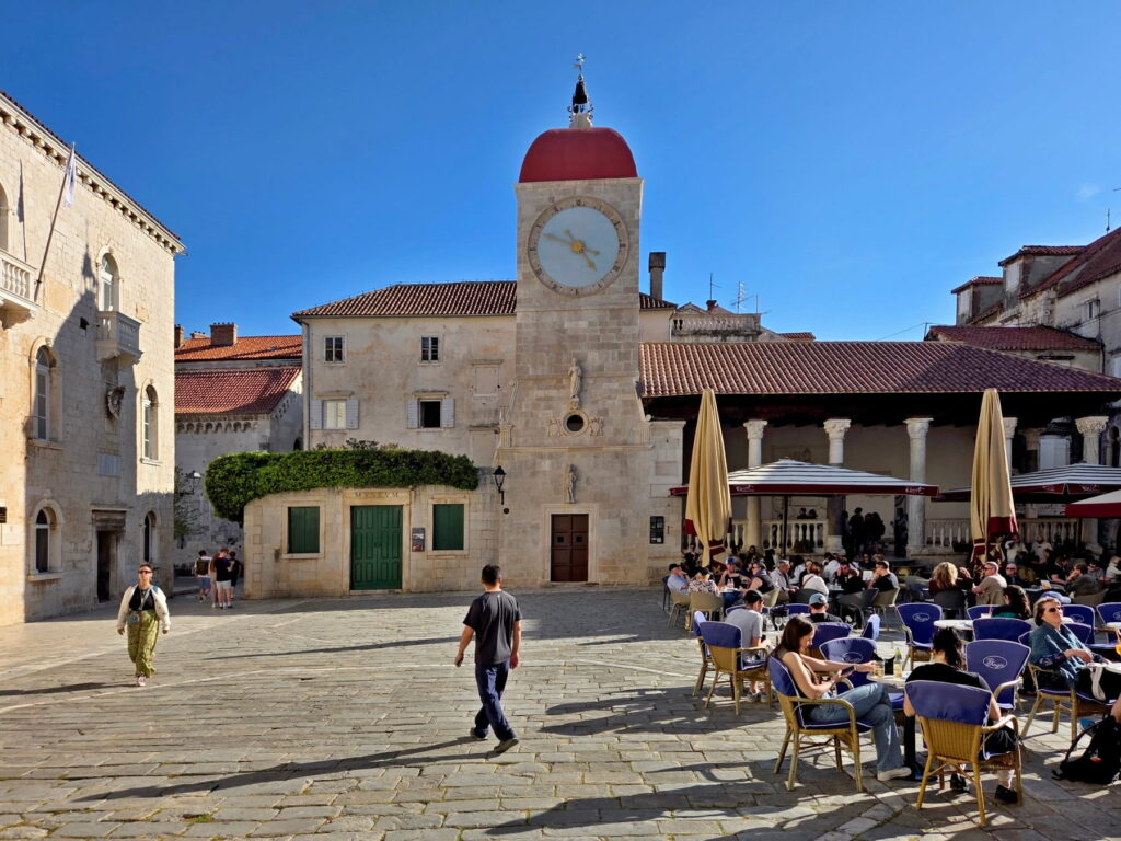 Clock tower square with cafés in Trogir, Croatia