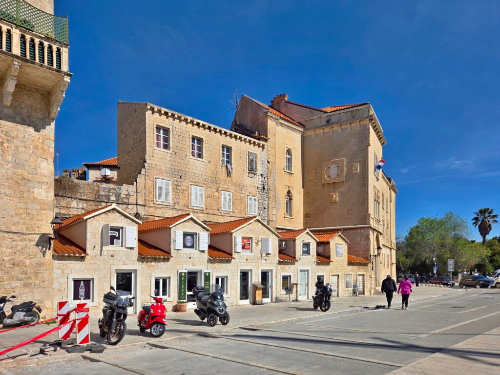 Historic stone buildings along the promenade in Trogir, Croatia