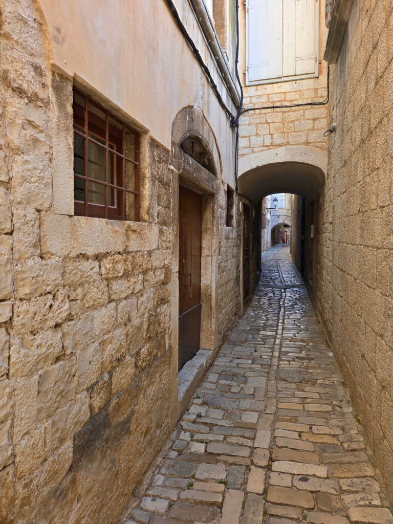 Narrow stone alley in Trogir old town, Croatia