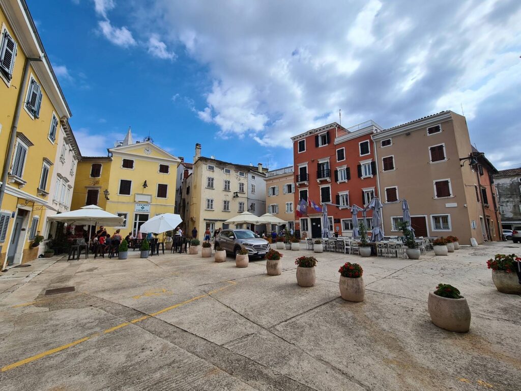 Main square with cafés and colorful buildings in Vrsar, Croatia