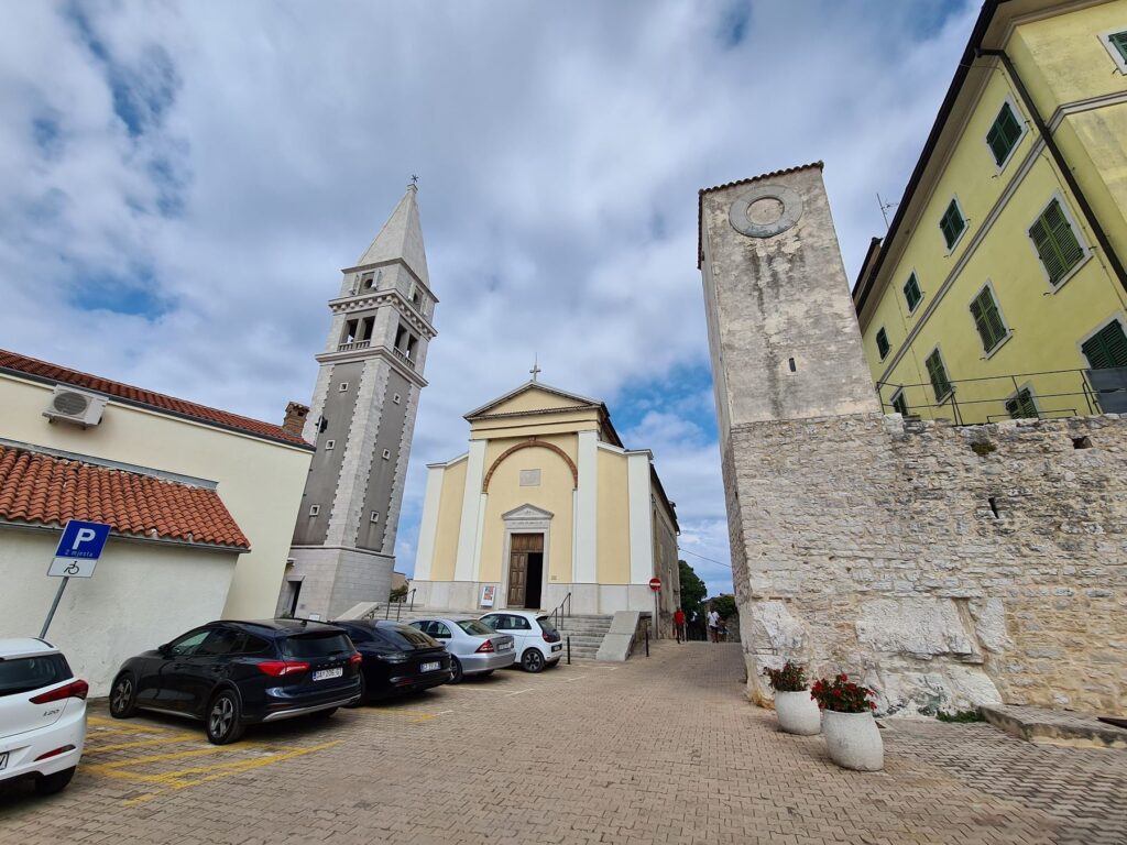 Church bell tower and historic stone buildings in Vrsar, Croatia