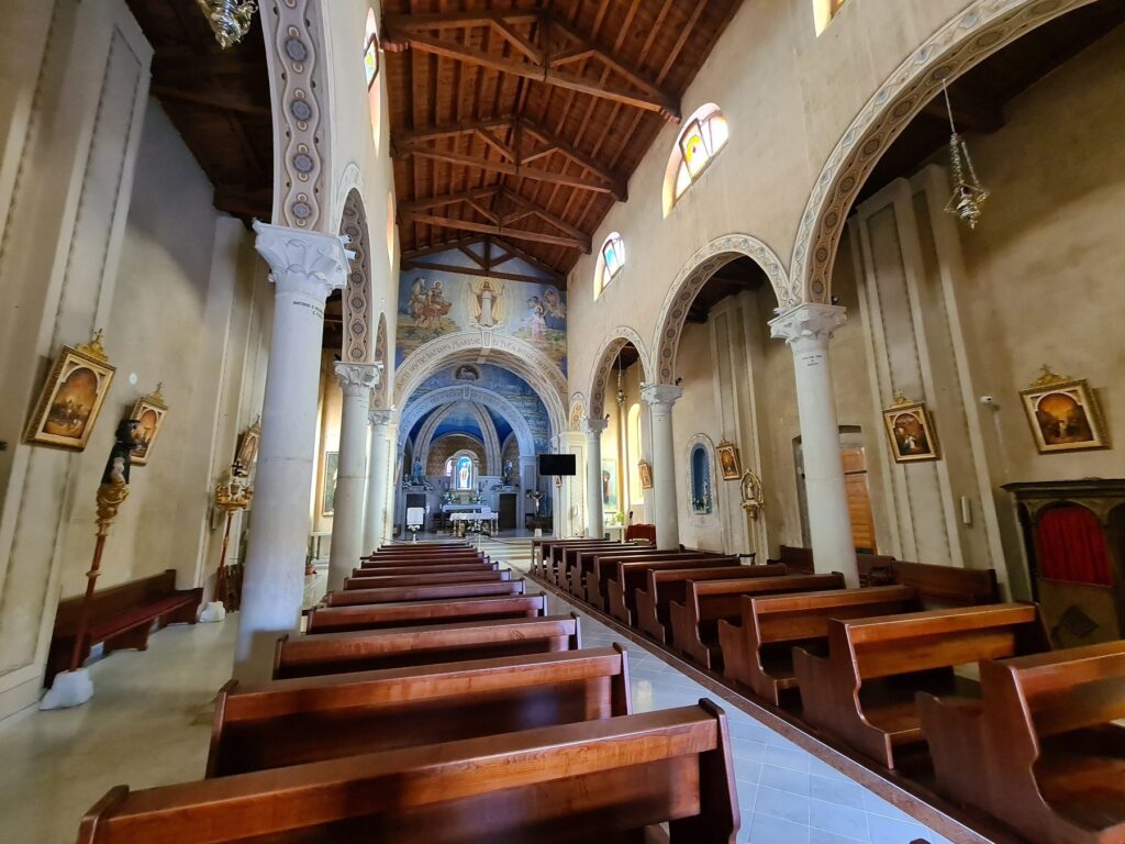Interior of the parish church in Vrsar, Croatia with wooden ceiling and arches