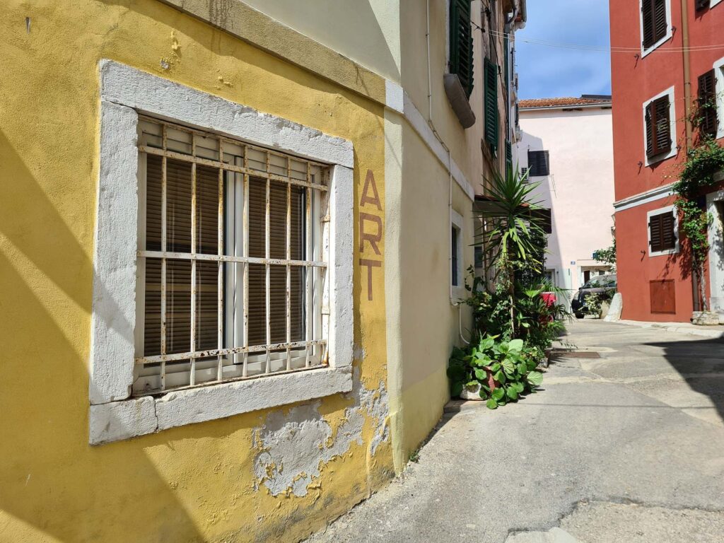 Narrow street with colorful houses in Vrsar old town, Croatia