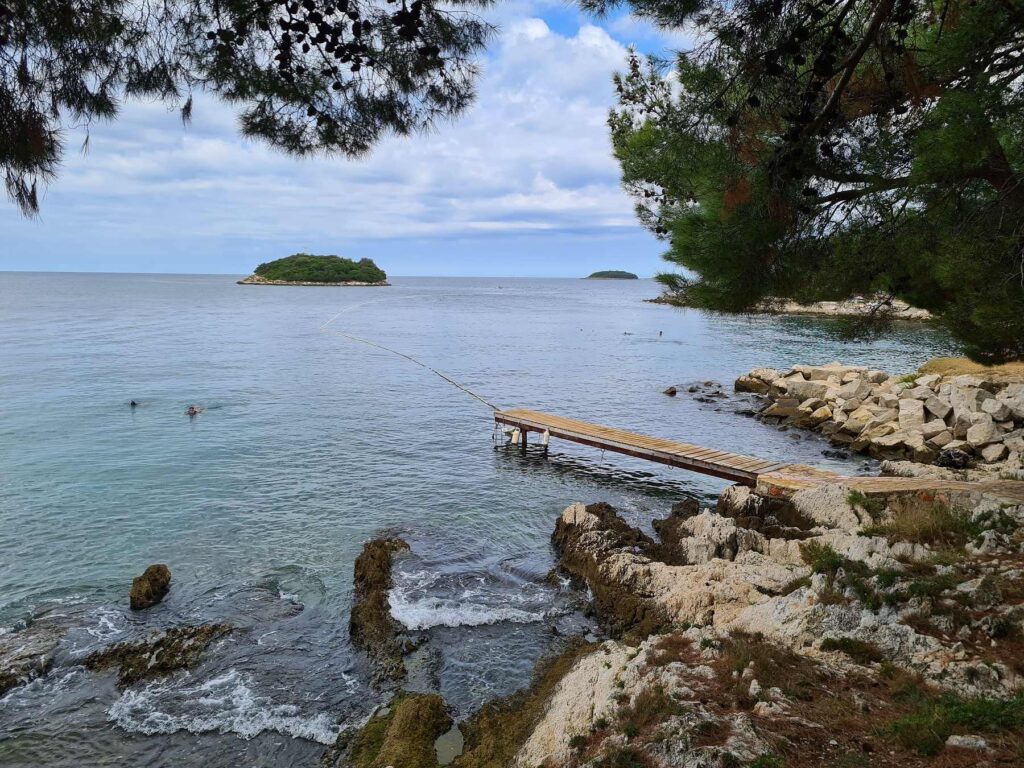 Rocky Adriatic coastline with wooden pier near Vrsar, Croatia