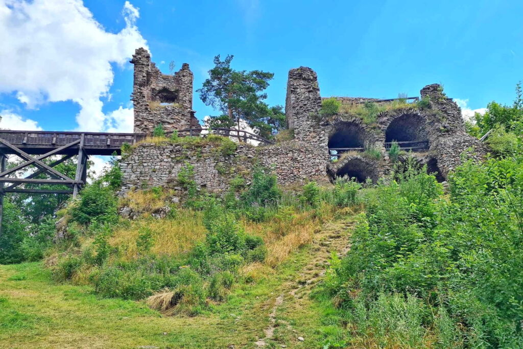 Zubštejn Castle ruins with stone walls and wooden bridge in the Czech Highlands
