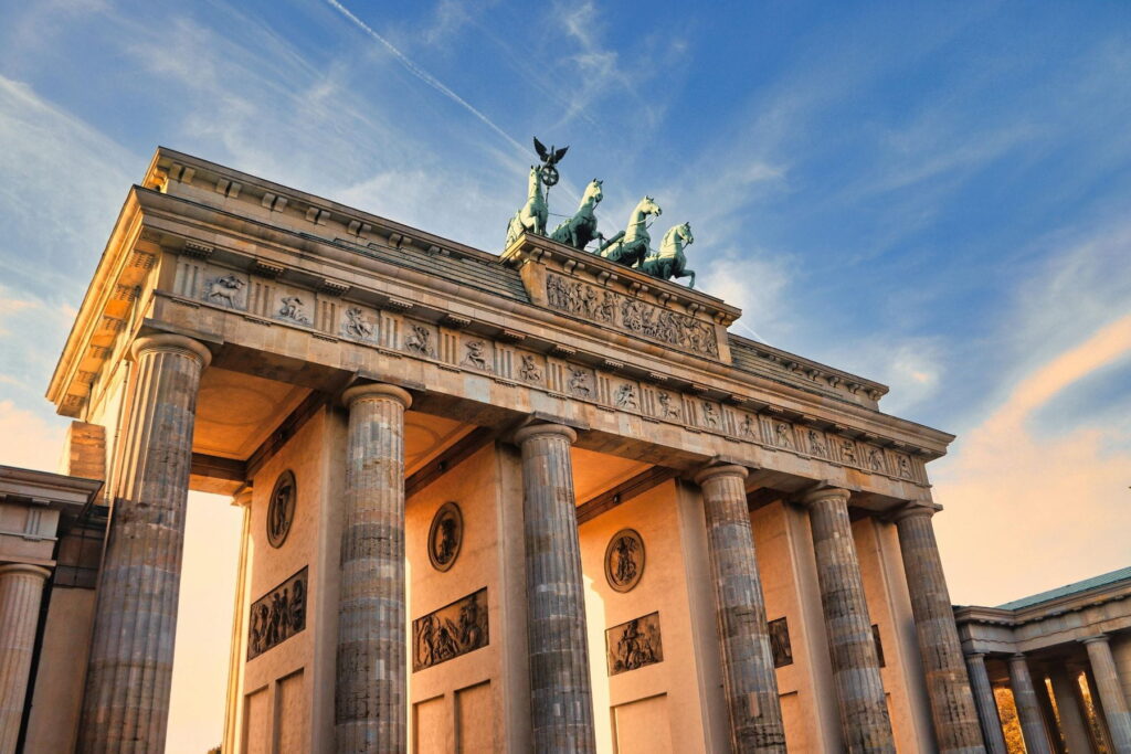 Brandenburg Gate illuminated at sunset in Berlin, Germany
