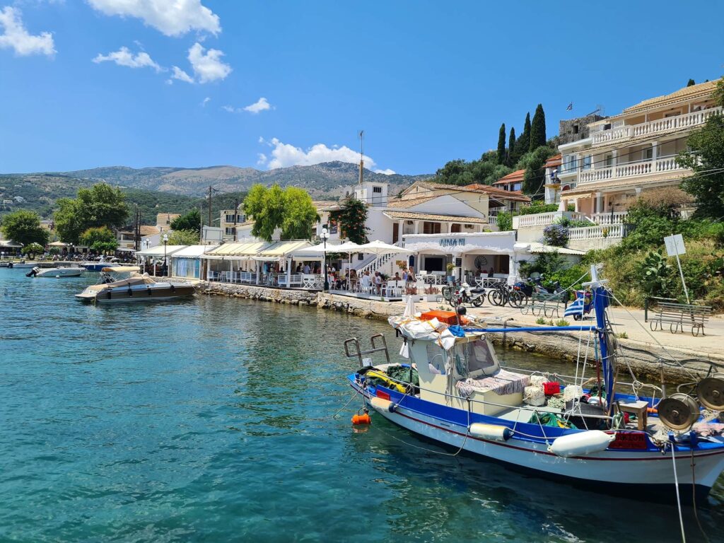 Fishing boat near waterfront tavernas in Kassiopi, Corfu, Greece