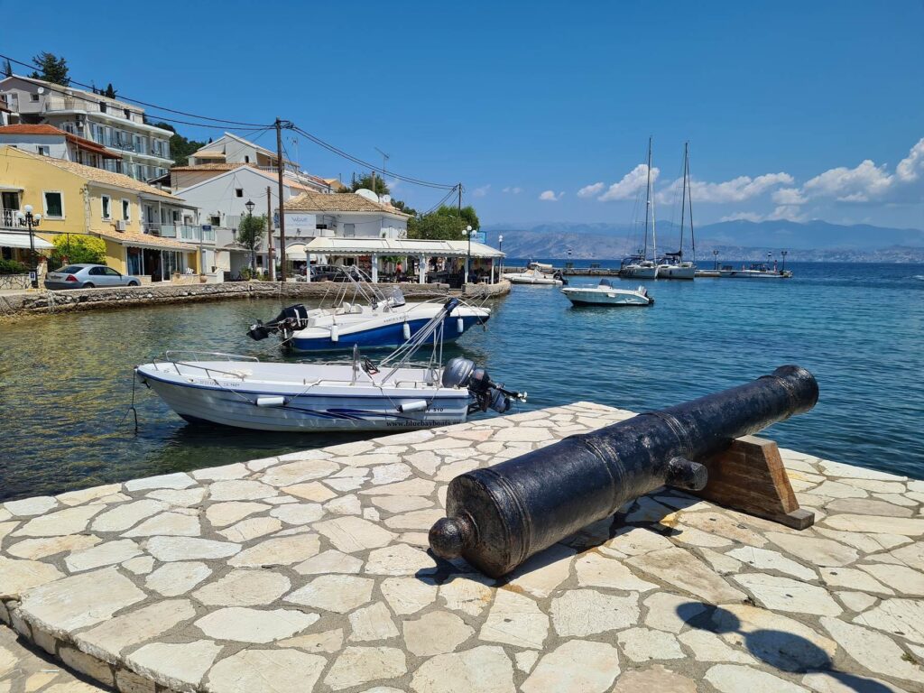 Old cannon overlooking the harbor in Kassiopi, Corfu, Greece