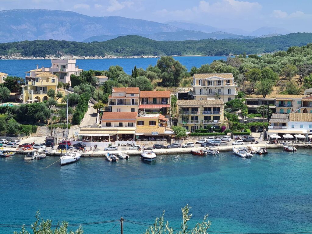 Seafront houses and boats in Kassiopi Bay, Corfu, Greece
