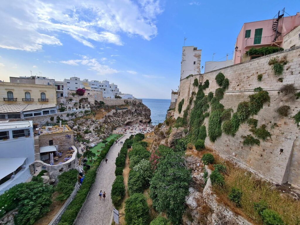 Cliffside walkway leading to Lama Monachile in Polignano a Mare, Italy