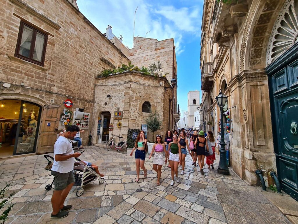 Historic stone street with shops in Polignano a Mare old town, Italy