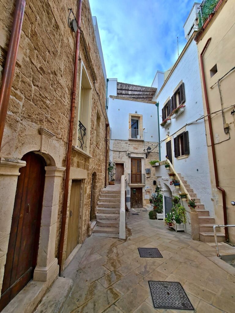 Traditional stone alley with staircases in Polignano a Mare, Italy
