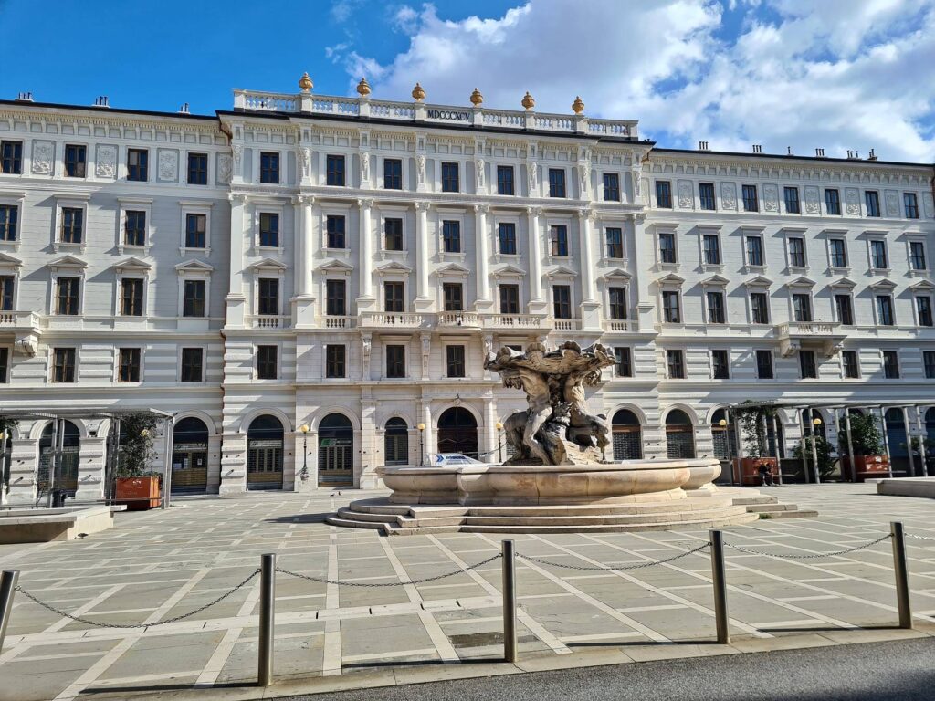 Historic neoclassical building and fountain in Trieste city center, Italy