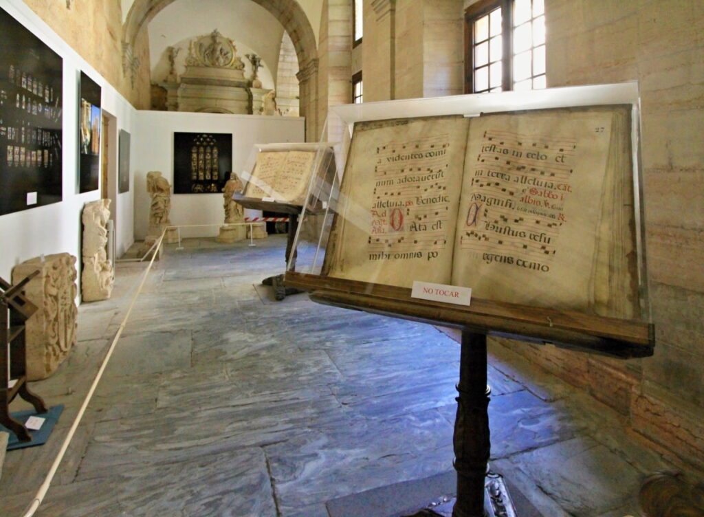 Historic choir book displayed inside a museum hall in Astorga Cathedral, Spain.