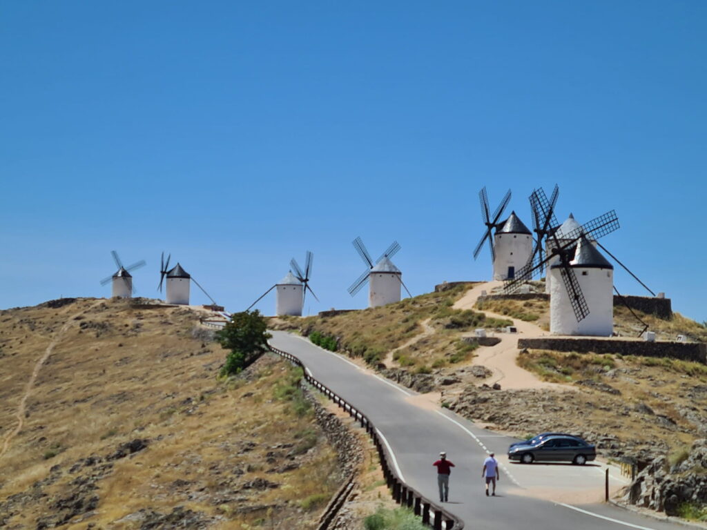 Scenic road leading to the historic windmills of Consuegra, Spain.