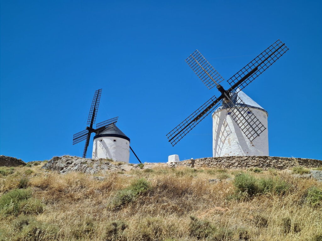 Two traditional windmills on Cerro Calderico hill in Consuegra, Spain.