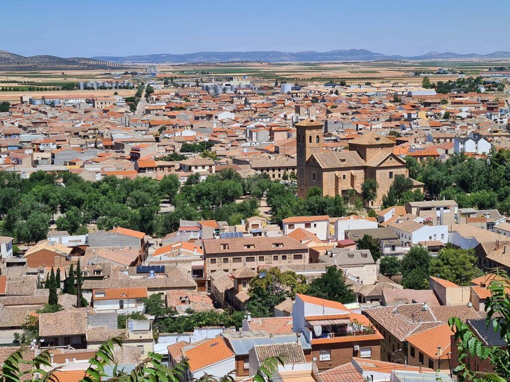 Panoramic view of Consuegra, Spain with church and surrounding plains.