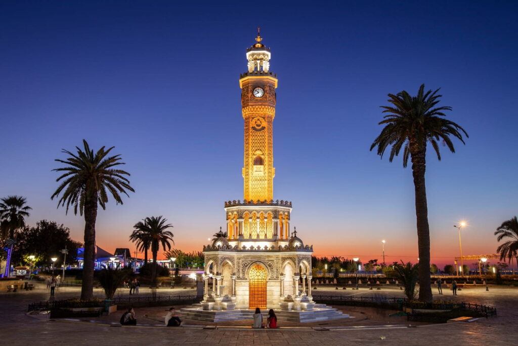 Izmir Clock Tower illuminated at dusk in Konak Square, Izmir, Turkey